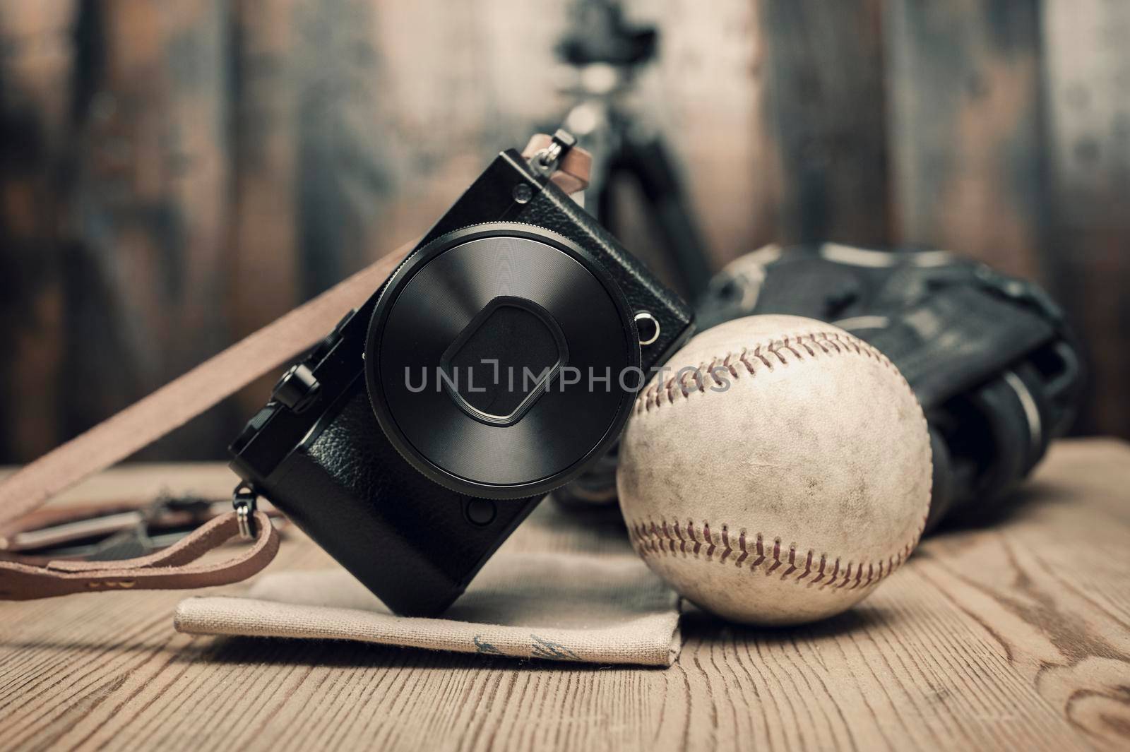 closeup vintage style of digital mirrorless camera with leather strap.