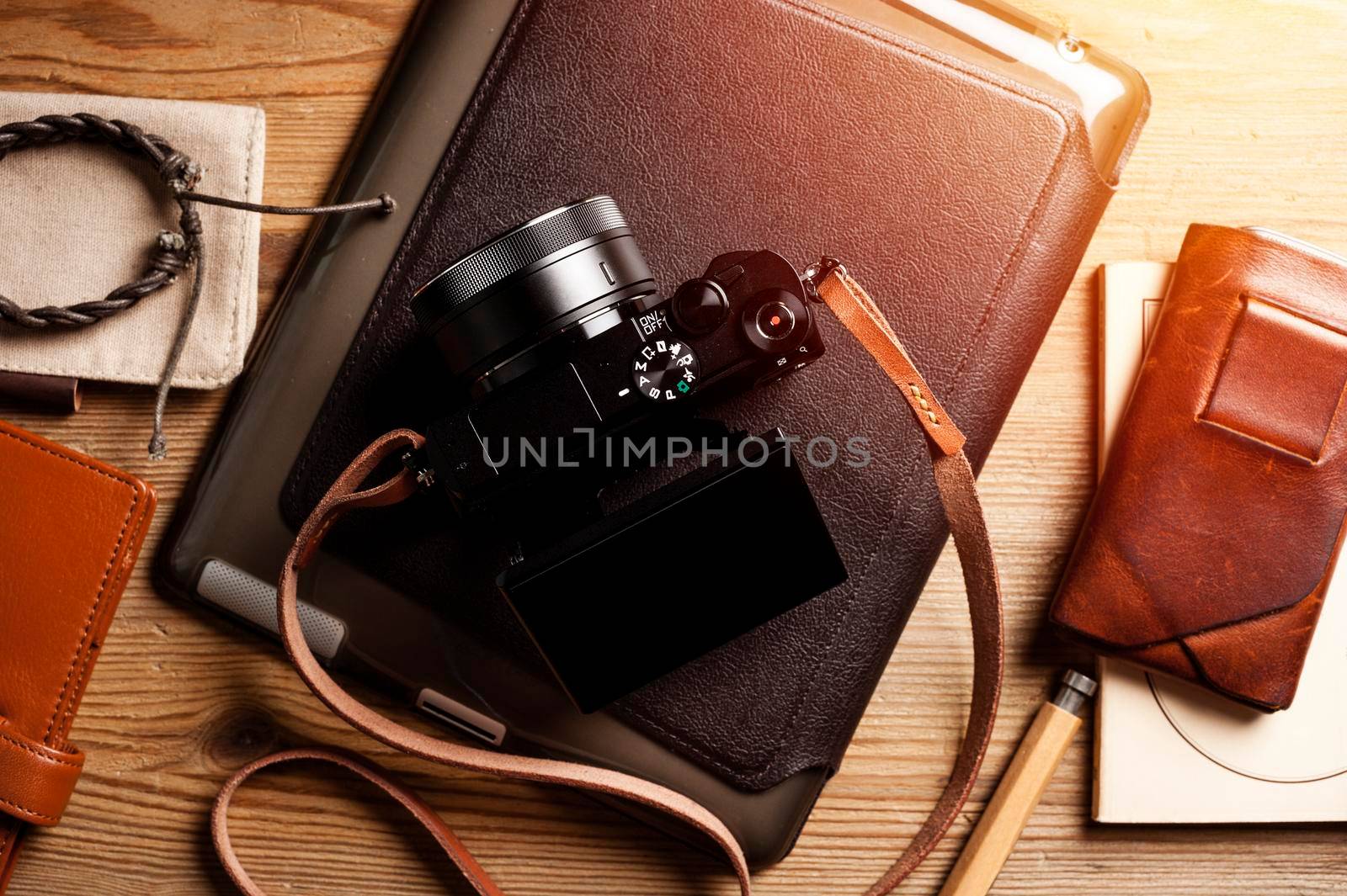 vintage style of digital mirrorless camera with leather strap with men's accessories and gadgets