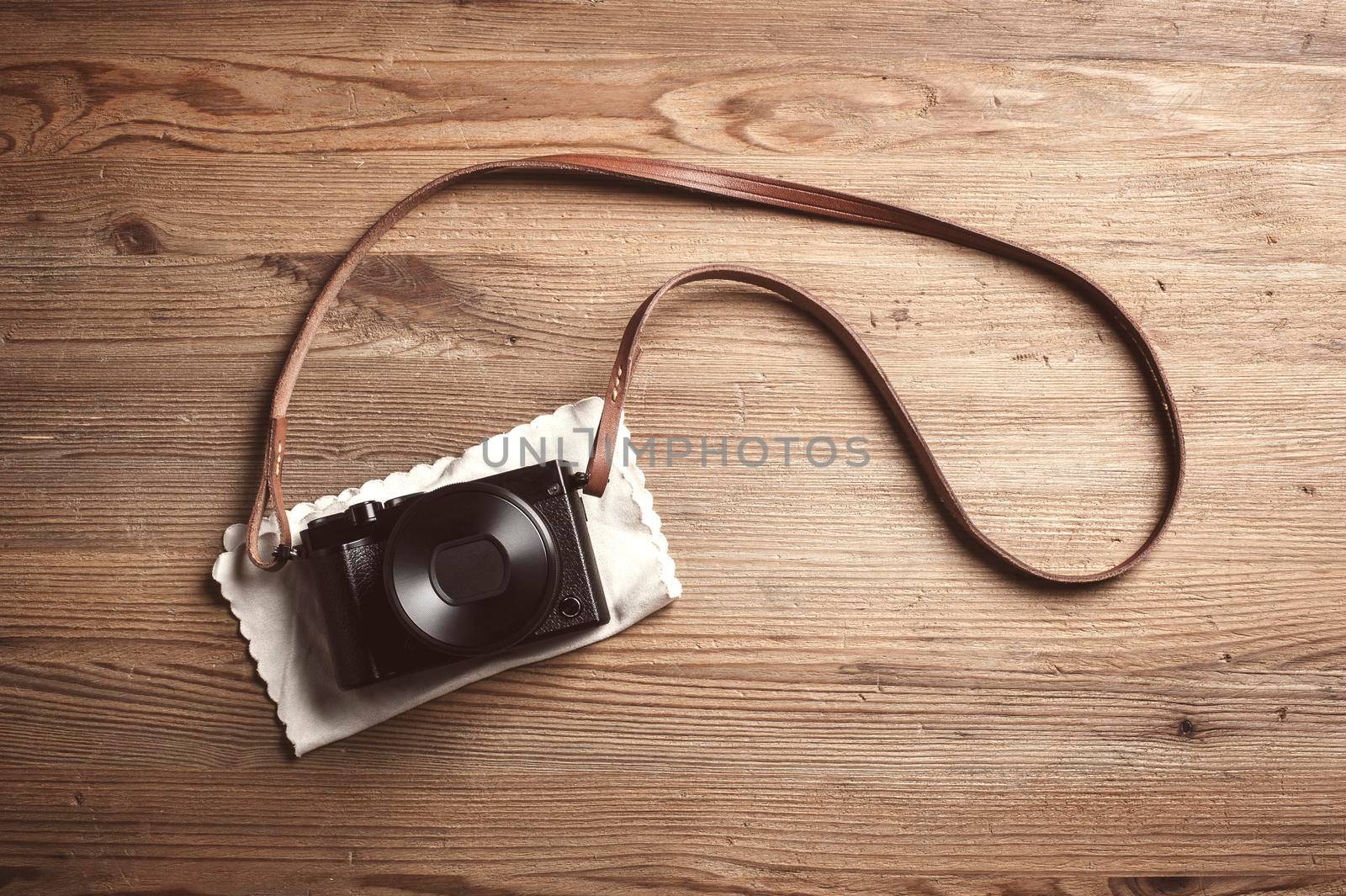 mirrorless camera on wooden background by norgal