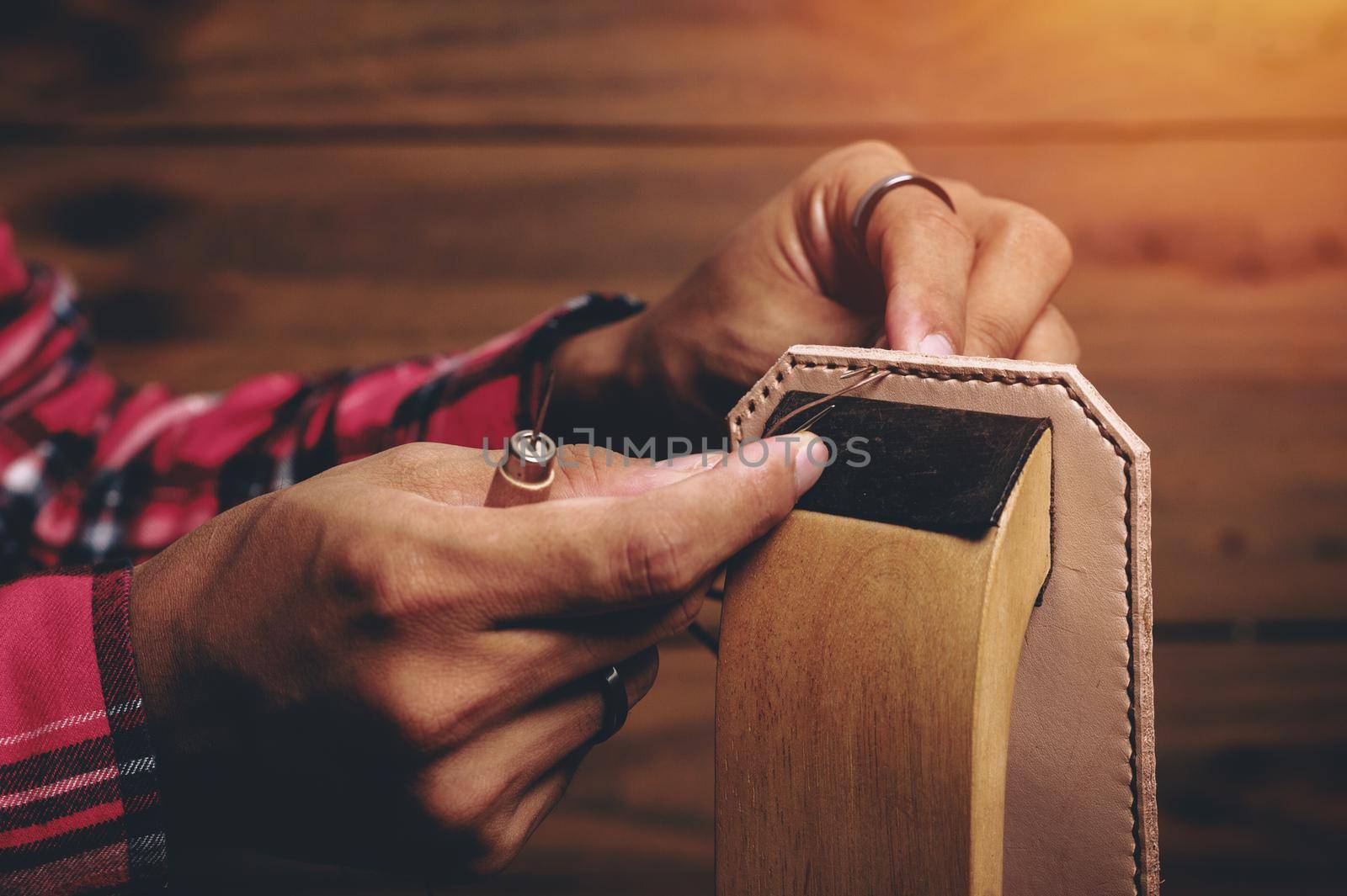 Sewing the vegetable tanned leather by hand. Leather and the craft tools.