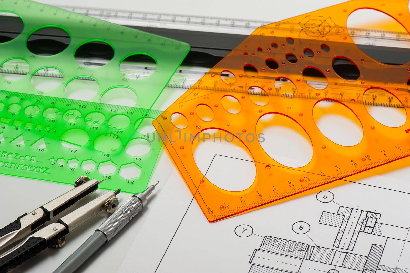 plastic technical drawing templates on engineer's desktop, tool for industrial drawing