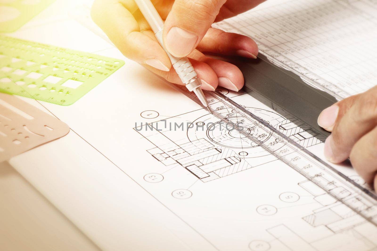 closeup technician's hand while using the industrial drawing tools, industrail drawing concept.