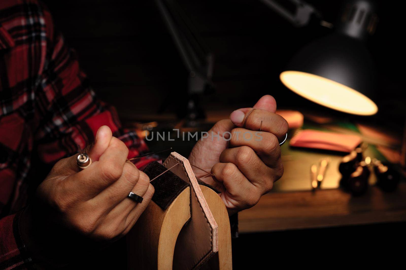 Sewing the vegetable tanned leather by hand. Leather and the craft tools.