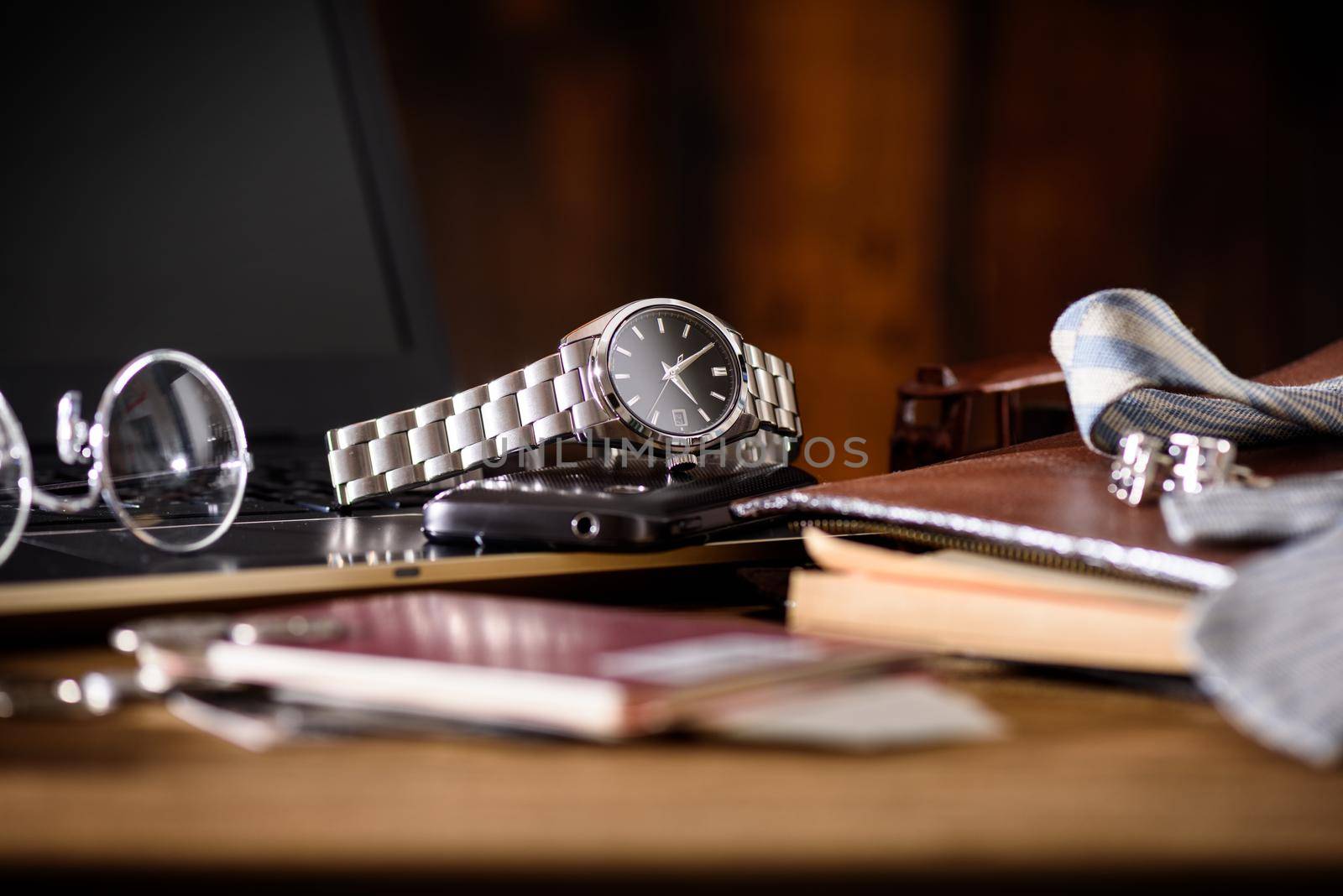 men's accessories, closeup at the luxury automatic wristwatch with black dial and stainless steel bracelet.