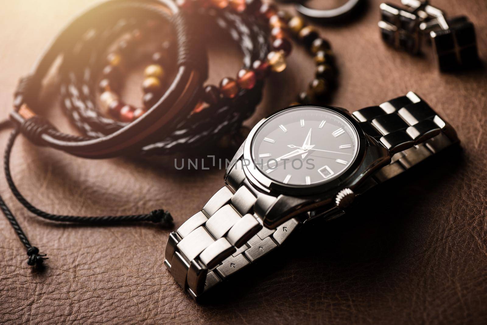 closeup luxury automatic wristwatch for men with black dial and stainless steel bracelet.