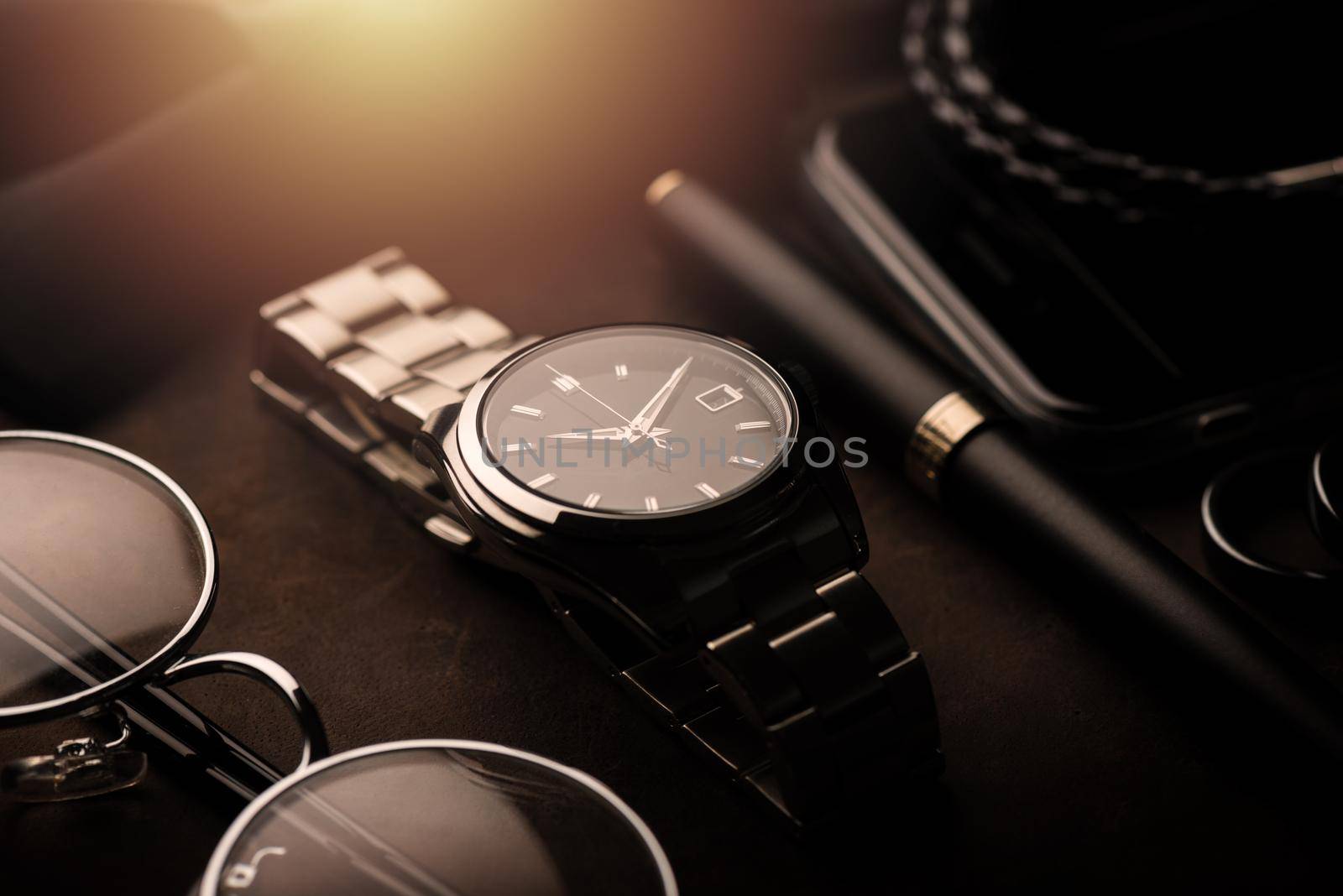 closeup luxury automatic wristwatch for men with black dial and stainless steel bracelet.