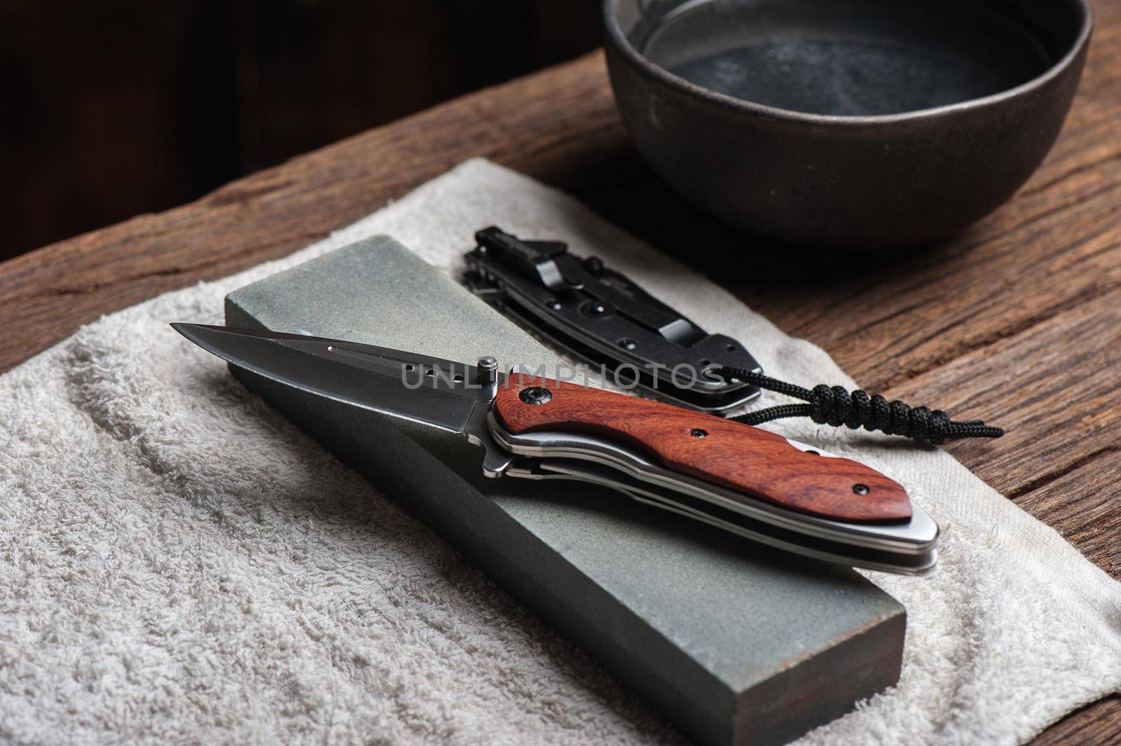 Sharpen the pocket knife with grindstone or whetstone. Pocket knife care and maintenance.