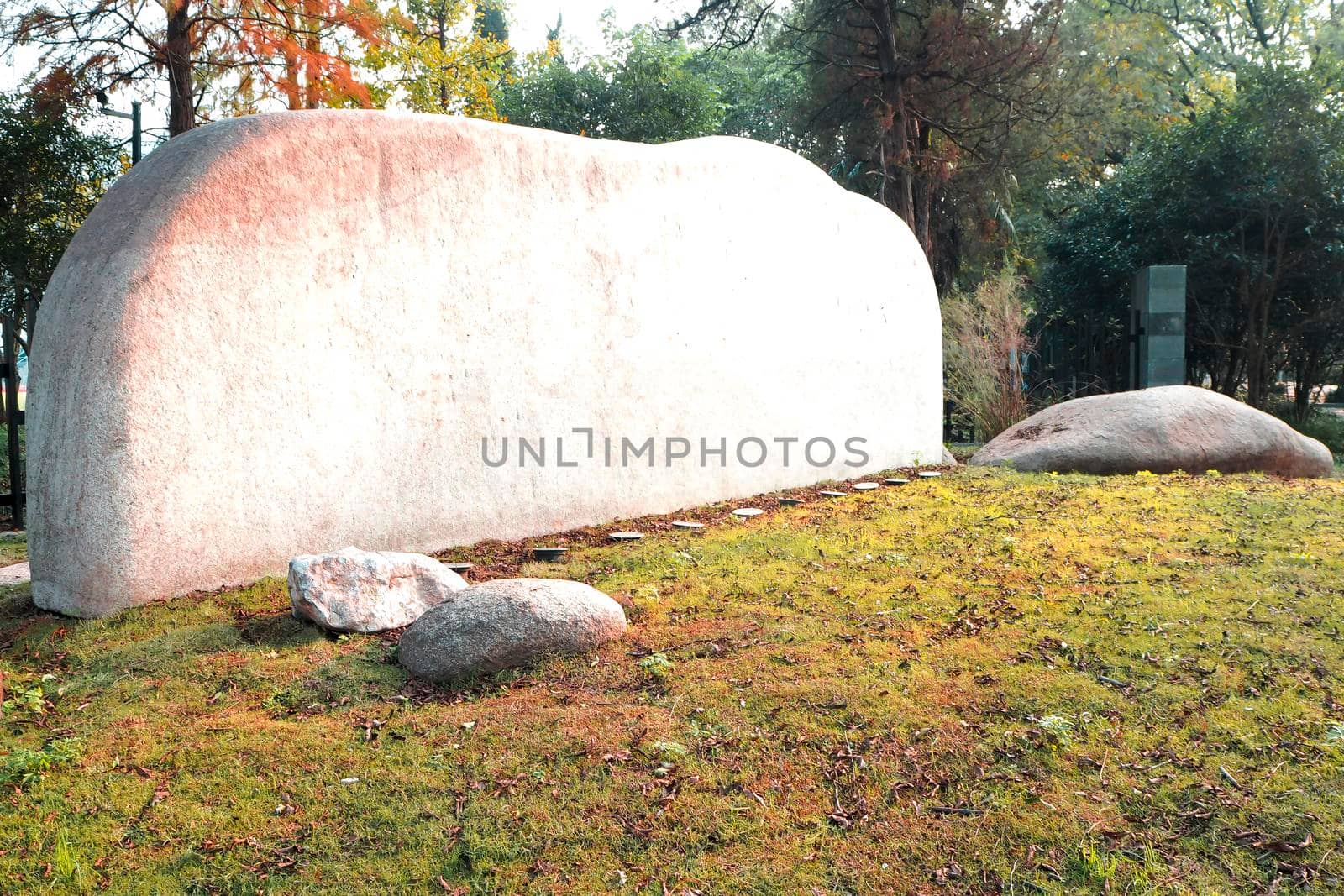 Empty space  for white Stone Tablet on Rock .engrave the name text information in public area .Park or entrance by Petrichor