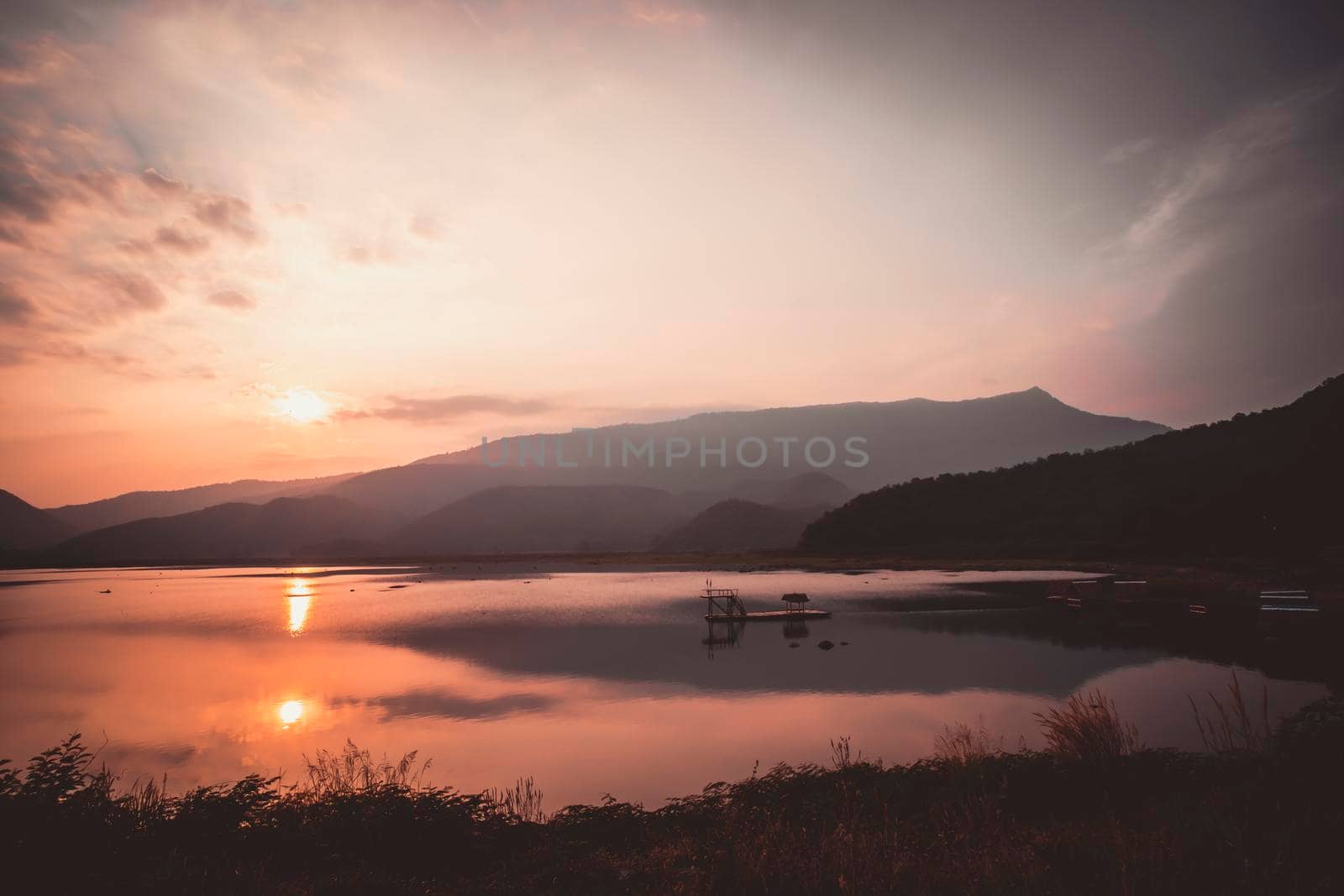 Mountain, sky and river in a quiet and cool atmosphere. Similar color scheme .View of blue mountains with reflection in lake . Landscape with blue mountains near lake in Sukhothai Thailand by Petrichor