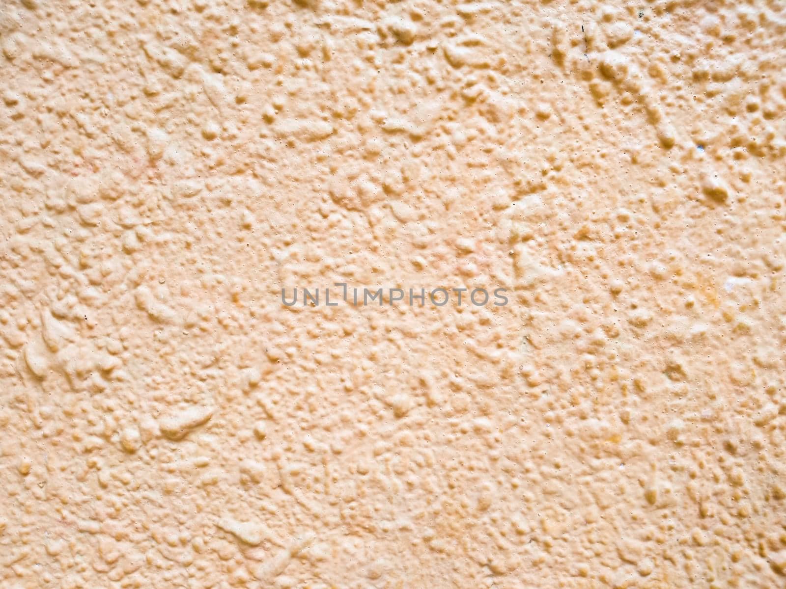 Abstract pink background texture concrete wall . the pink texture of the surface of the wall covered with decorative plaster of the woodworm type, close-up architecture abstract background