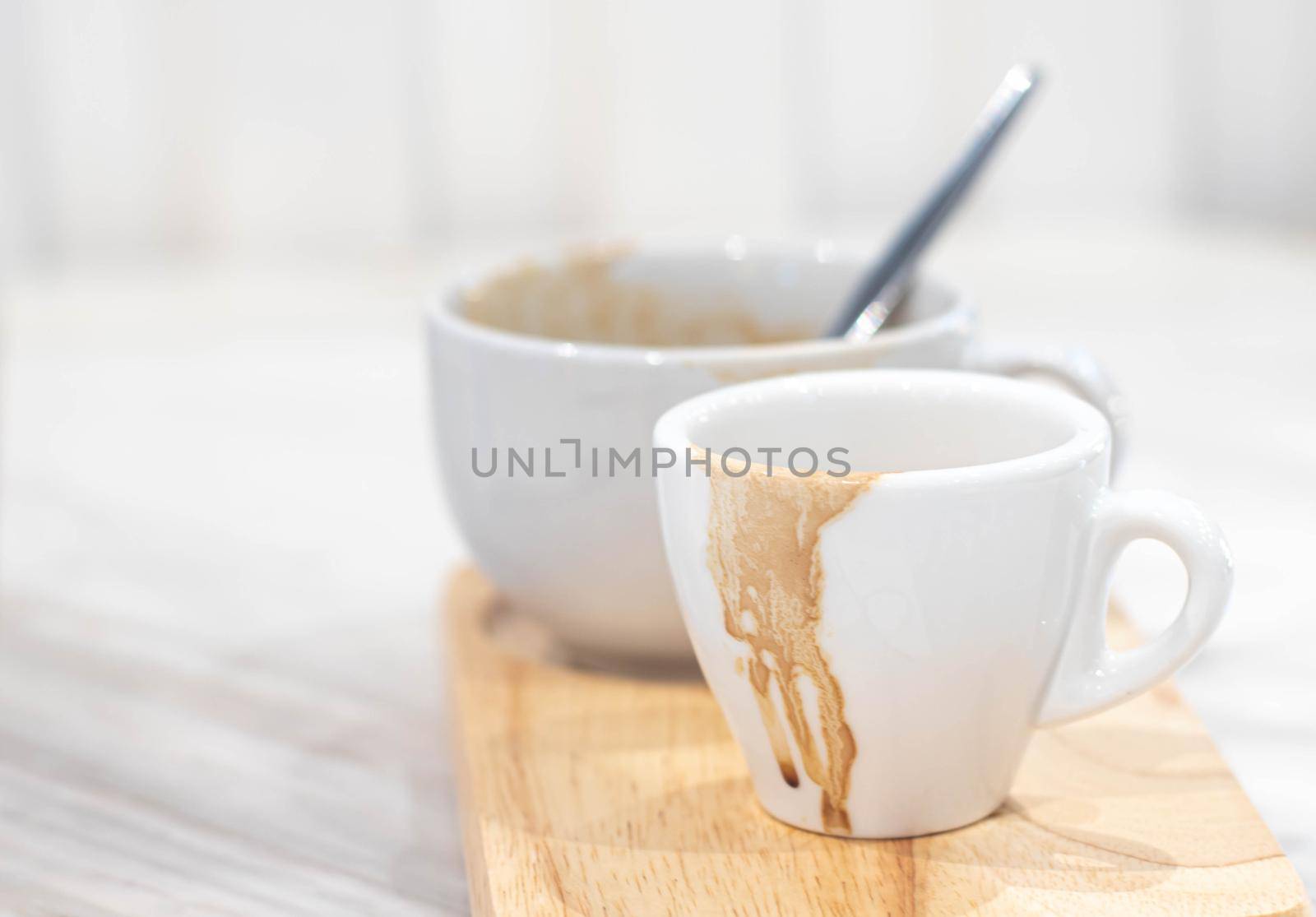 Dirty coffee white mug and Coffee mug stain on wooden plate. by Petrichor