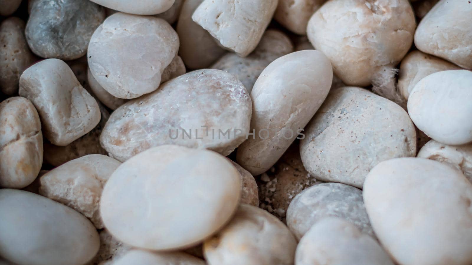 Close up natural white pebbles, texture of decorative stone gravel for background and design.
