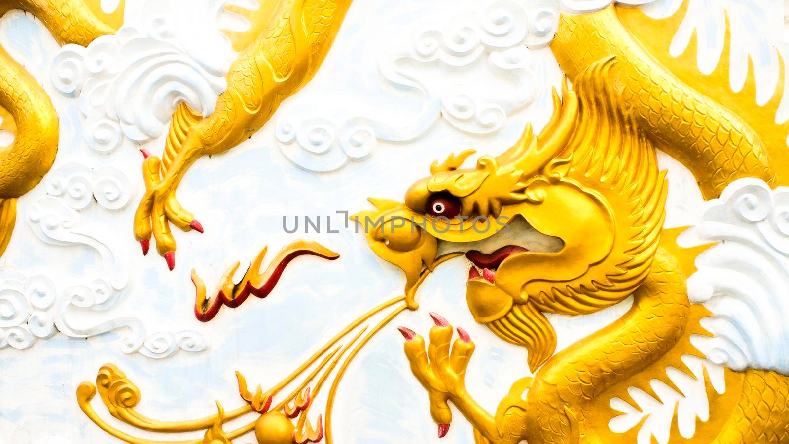 Abstract cultural art of Chinese Golden Dragon sculpture montage on wall ceiling of Asia temper architecture.