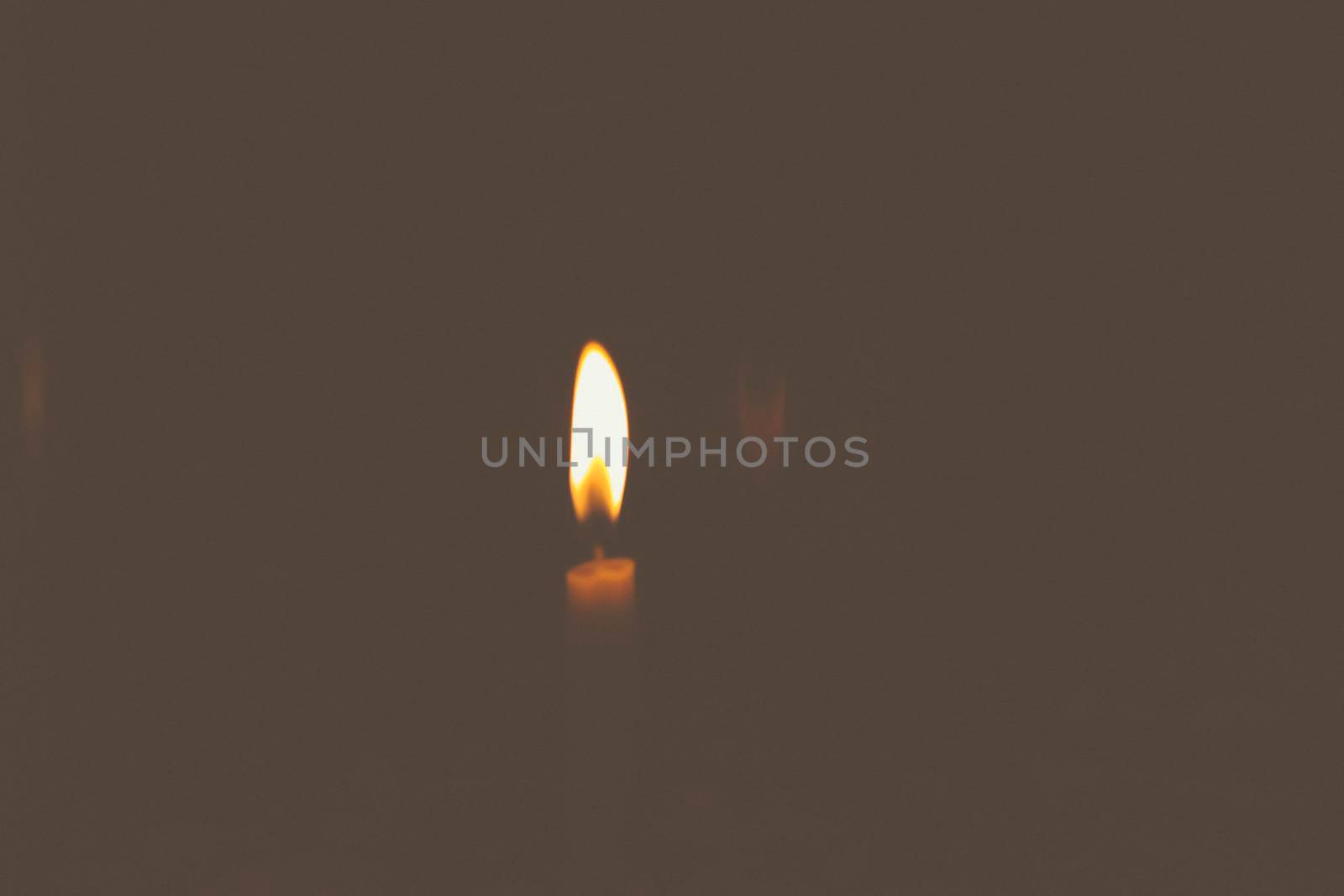 Blurred Defocus of A candle in the dark is blown out for using as Background. Hope concept idea by Petrichor