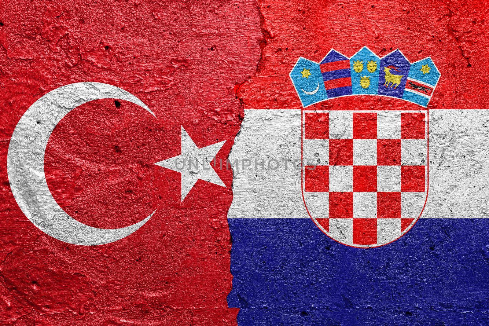Turkey and Croatia - Cracked concrete wall painted with a Turkish flag on the left and a Croatian flag on the right