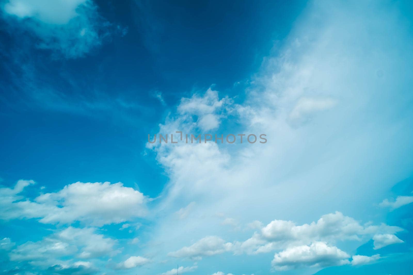White fluffy clouds against blue sky in summer nature season weather background