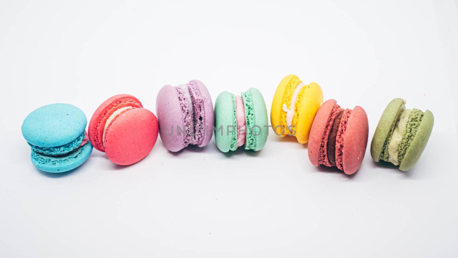 Pastel colored macarons sweet French dessert isolated on white background.