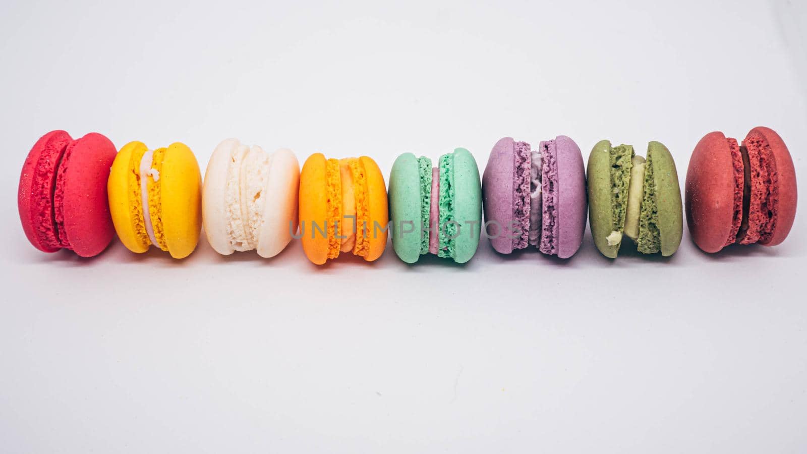 Pastel colored macarons sweet French dessert isolated on white background.