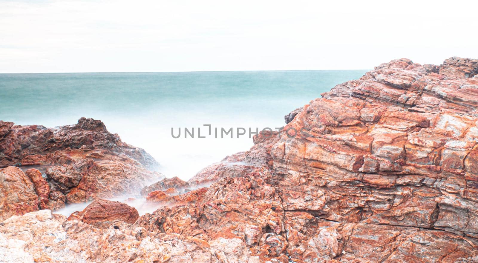 Long Exposure of Sea with Smooth Wave and Rock. Nature of Seascape abstract vacation travel in summer time.