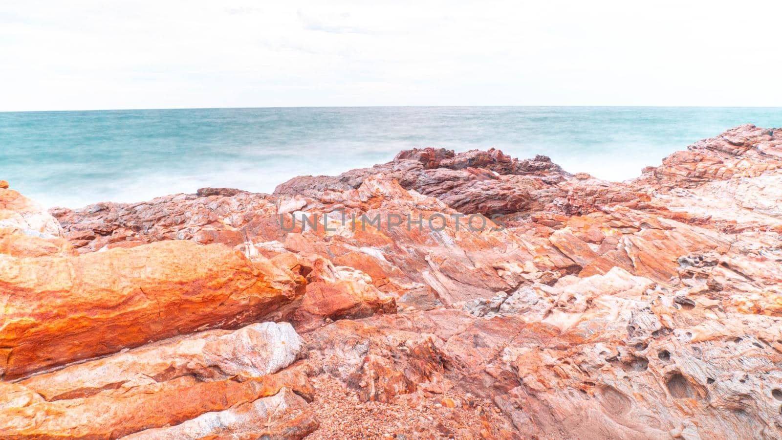 Long Exposure of Sea with Smooth Wave and Rock. Nature of Seascape abstract vacation travel in summer time.