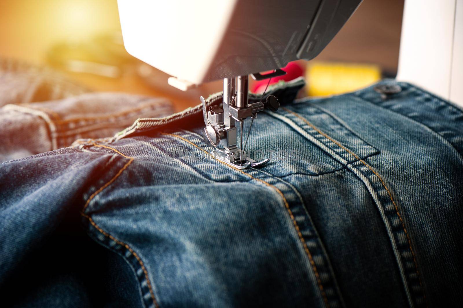 sewing indigo denim jacket with sewing machine, garment industrial concept.