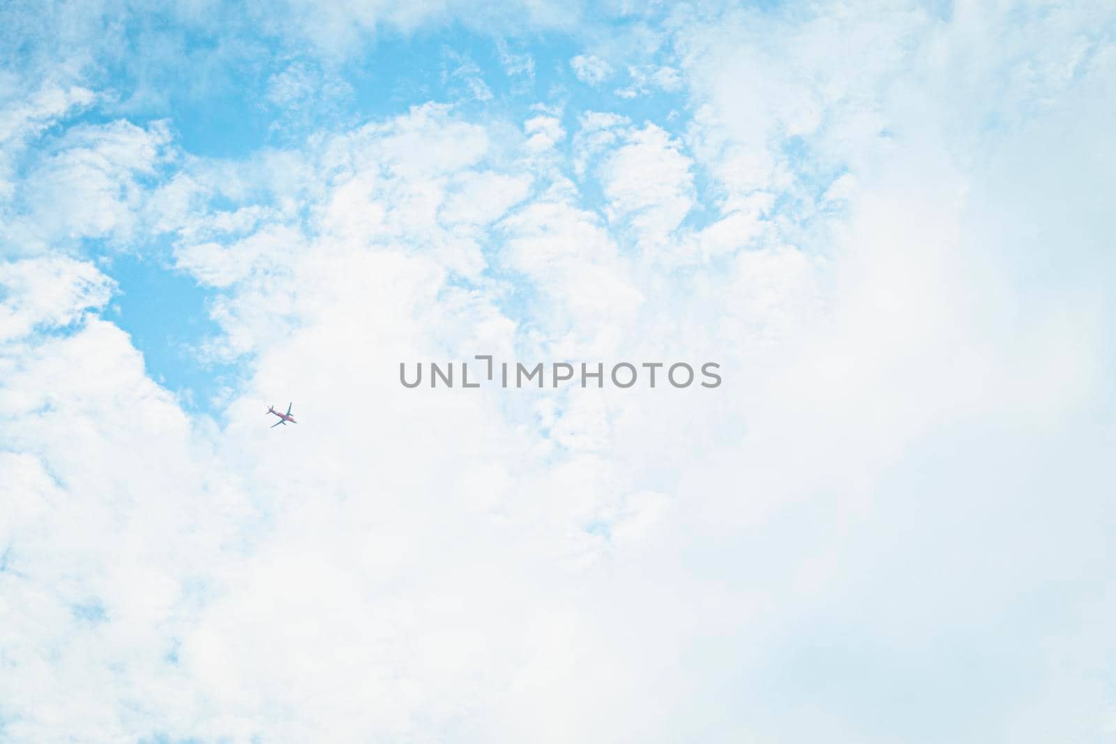 An airplane in Blue Sky Background With white Clouds. abstract sky summer season weather.