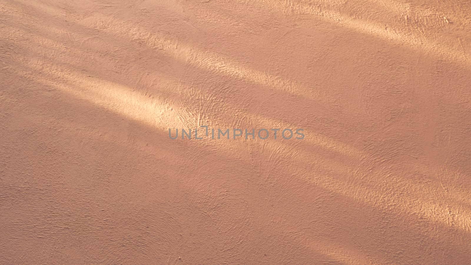 Abstract background from stucco concrete wall with sunlight, light and shadow
