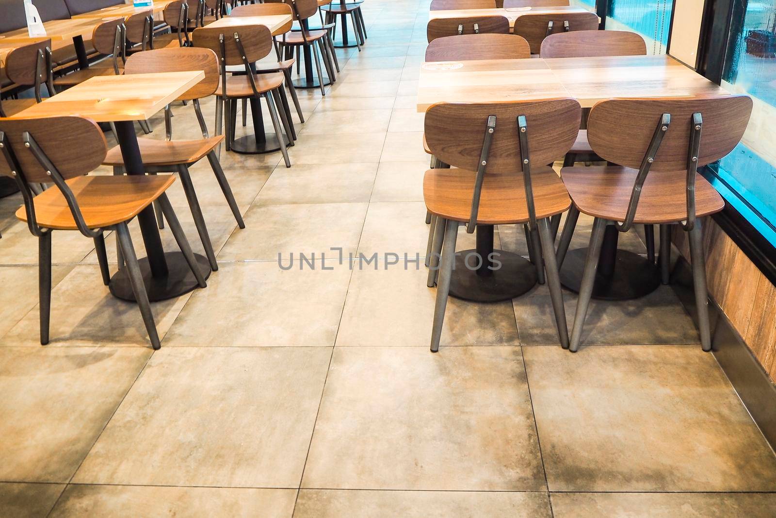Morning light through rows of  Empty table and chairs in cafe restaurant