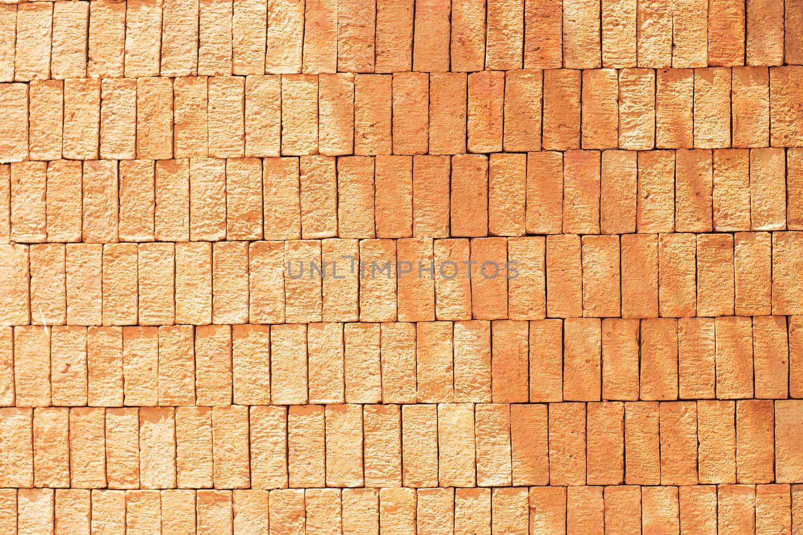 Rectangular orange bricks random pattern wall facade texture material in architecture exterior and interior.