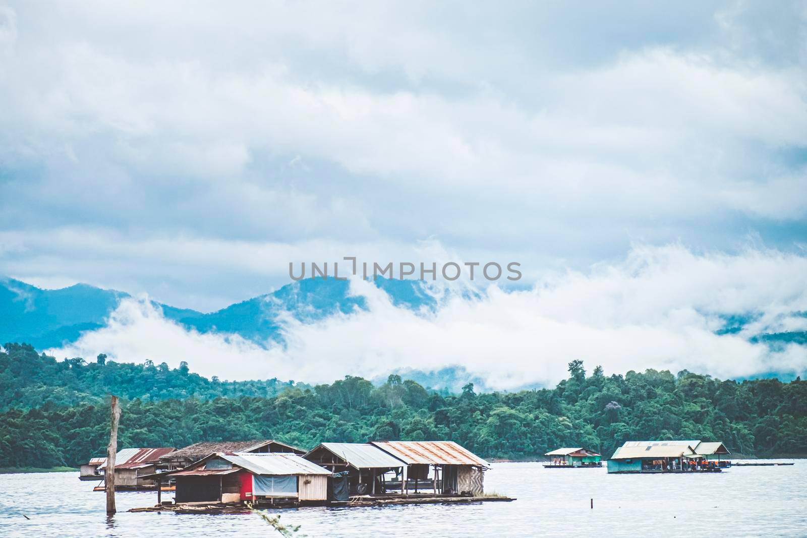 Panorama scenic of rafting house with Foggy Mountain in Autumn on lake by Petrichor