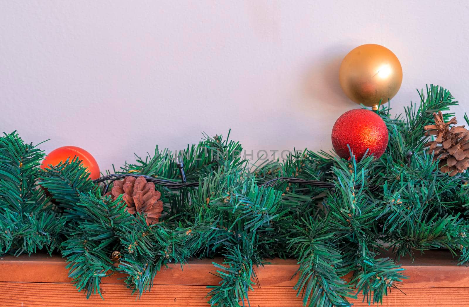 Christmas ornaments gold ball and red ball on wooden and white background.
