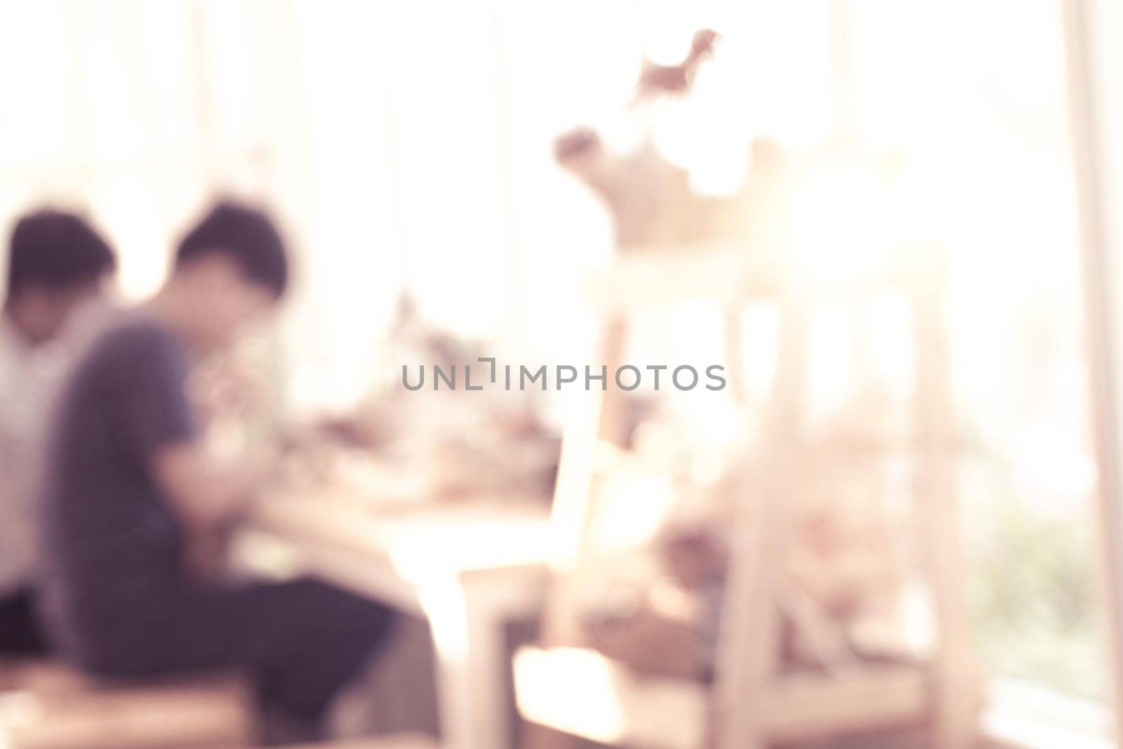 Abstract blur coffee shop background in warm tone. brightness background