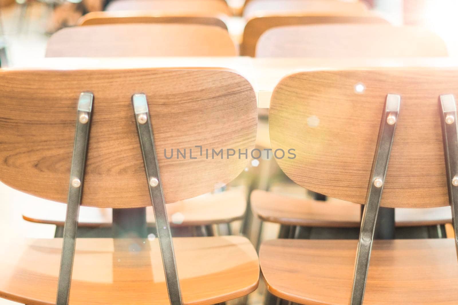 Morning light through rows of  Empty table and chairs in cafe restaurant