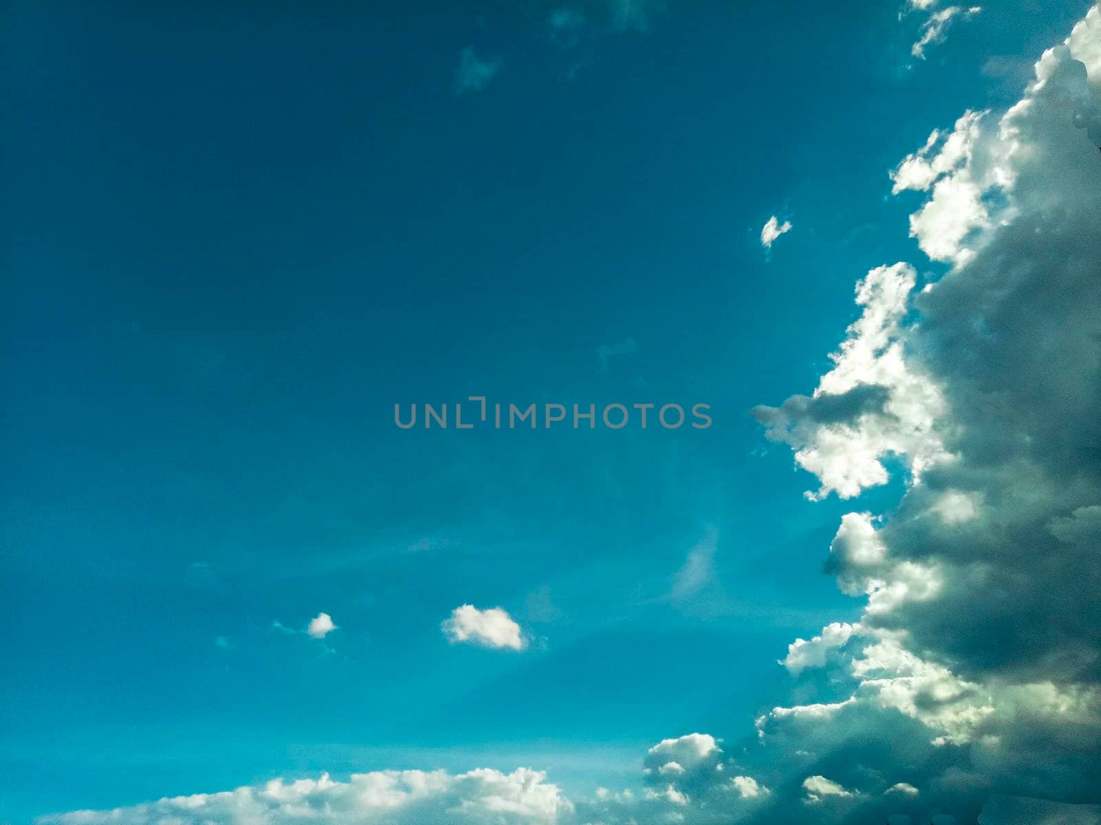 beautiful sky cloudscape .rim light behind dark cloud with blue sky background