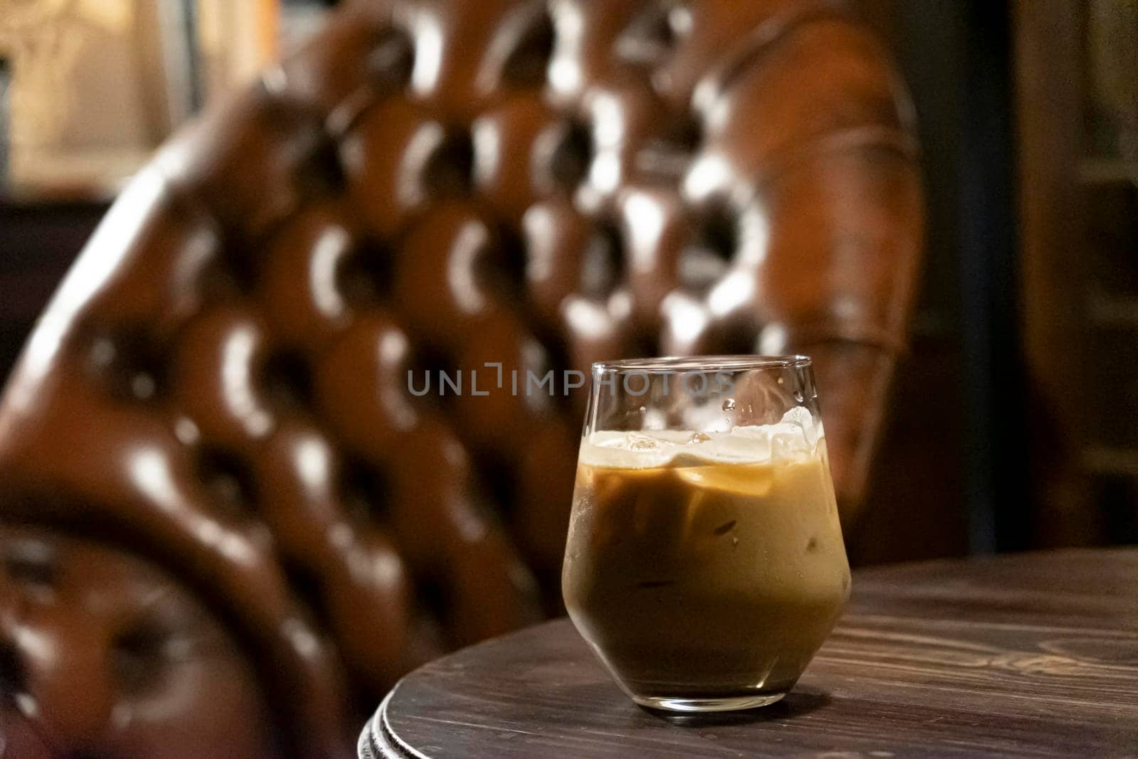 Iced latte coffee glass  on a dark brown tone background