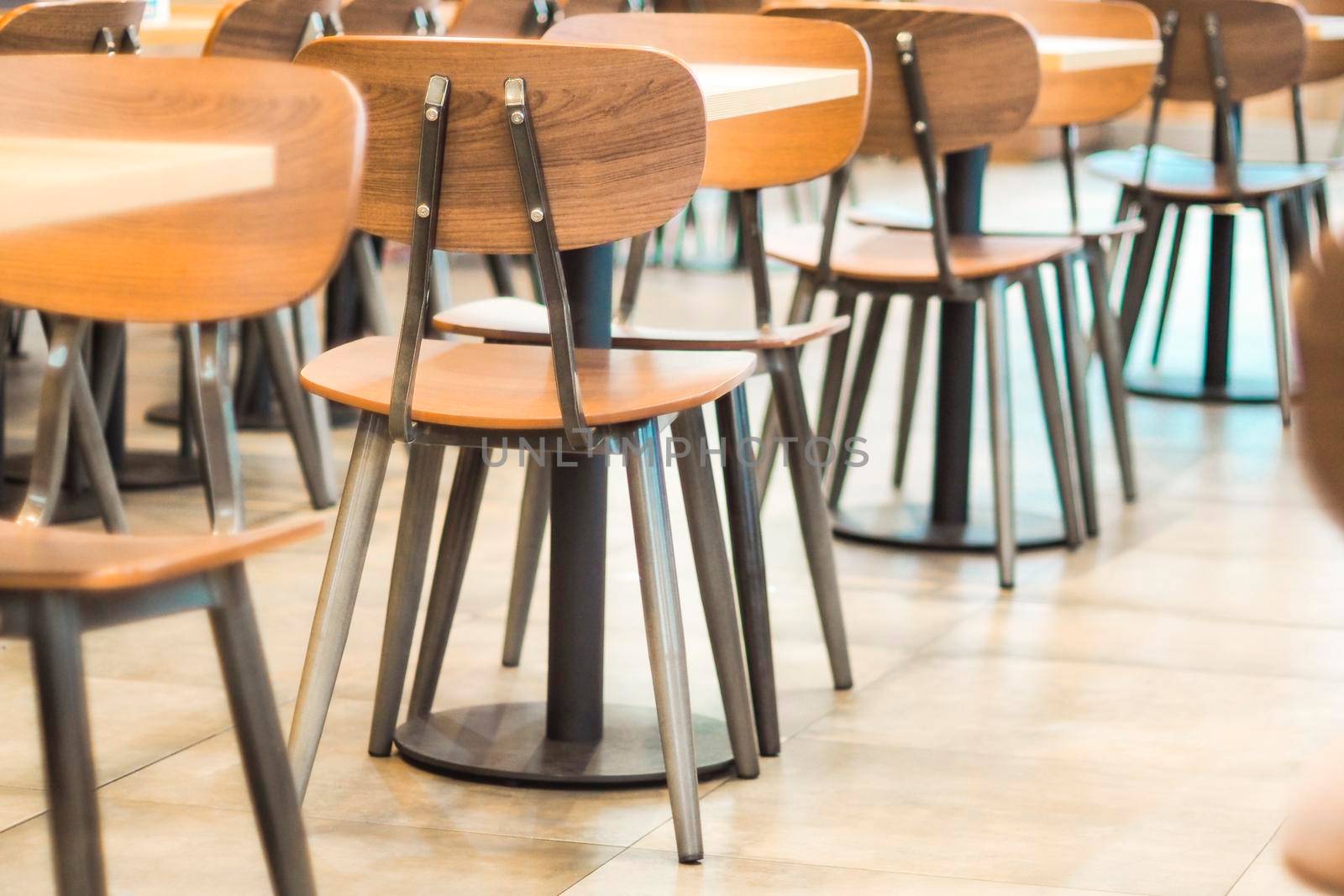 Morning light through rows of  Empty table and chairs in cafe restaurant
