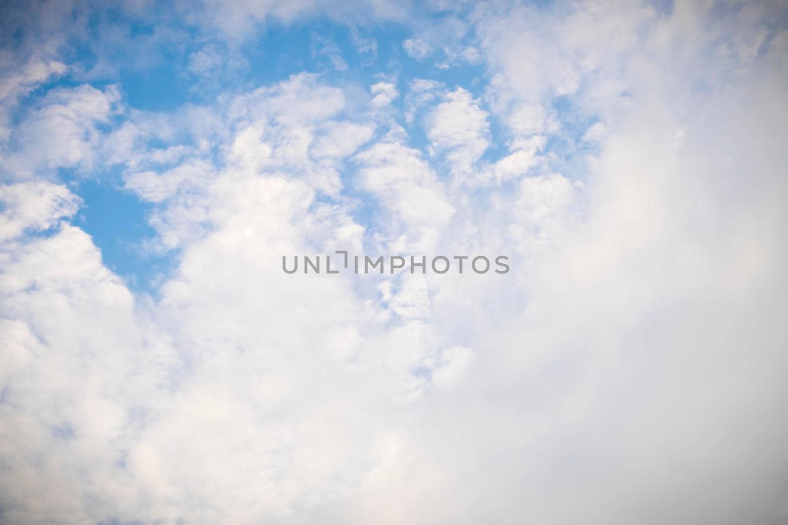 Beautiful white fluffy and cirrocumulus clouds on a blue sky background