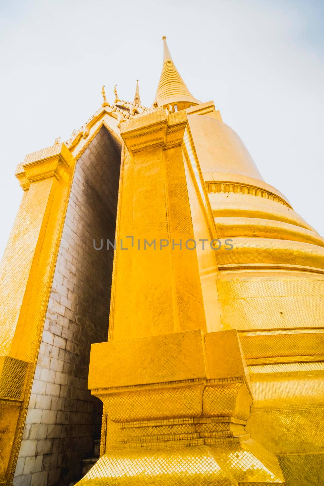 Golden Stupa of Temple of the Emerald Buddha.  Wat Phra Si Rattana Satsadaram.  Wat Phra Kaew. landmark of Bangkok Thailand with pink sky at dusk