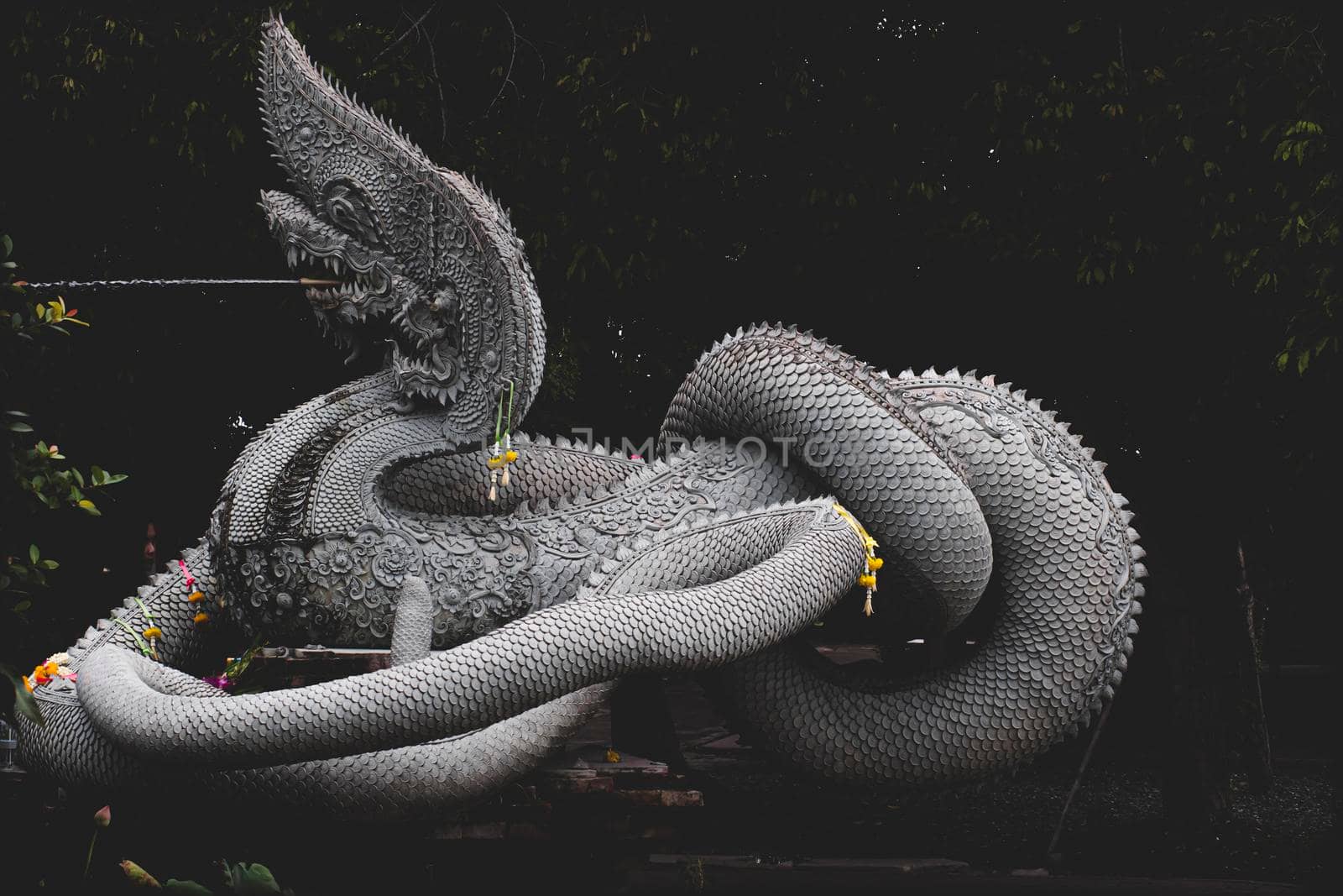 Sculpture of Dragon or Serpent or Naga legendary animal of Thailand at  Wat Kham Chanod 2 in Thailand by Petrichor