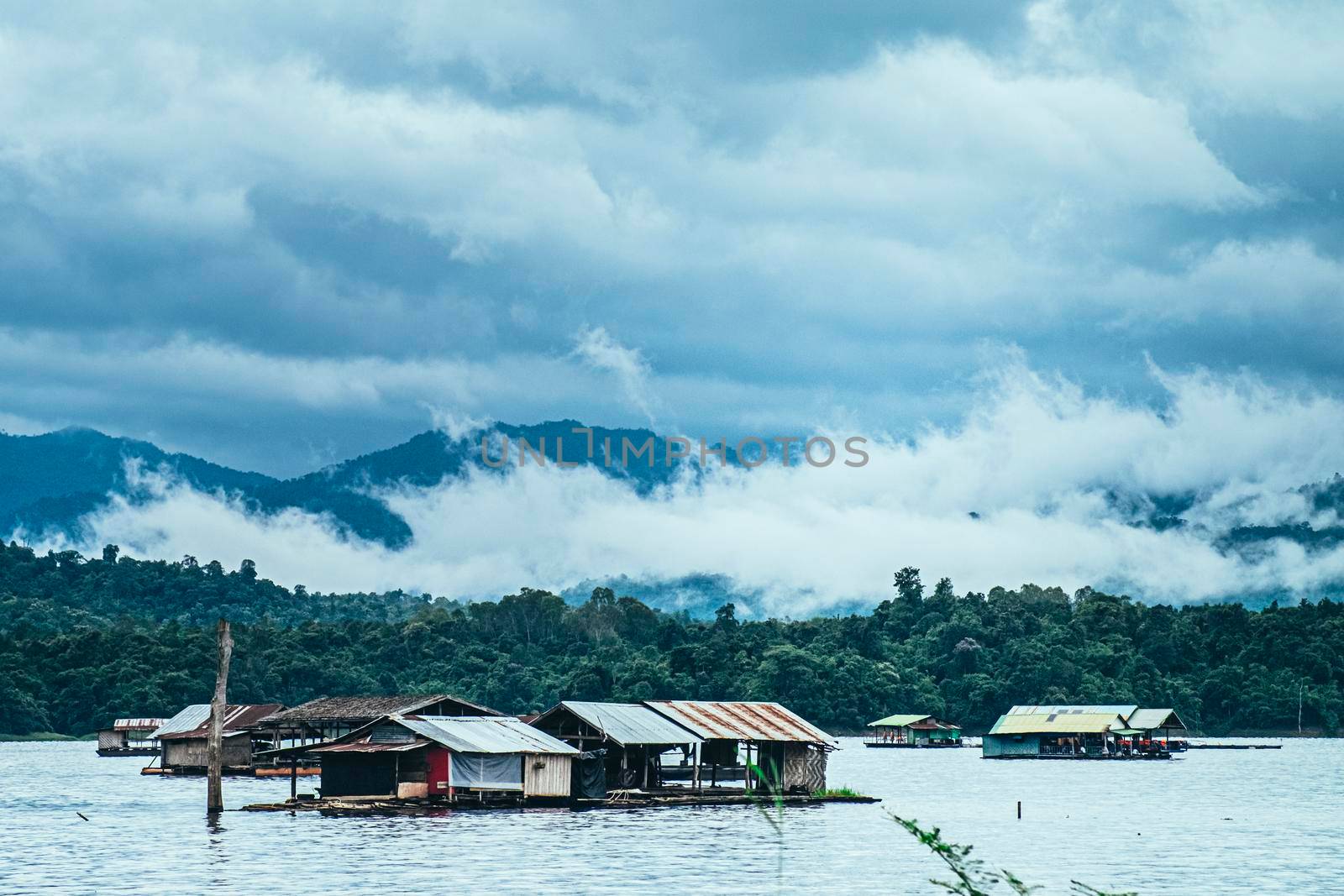Panorama scenic of rafting house with Foggy Mountain in Autumn on lake