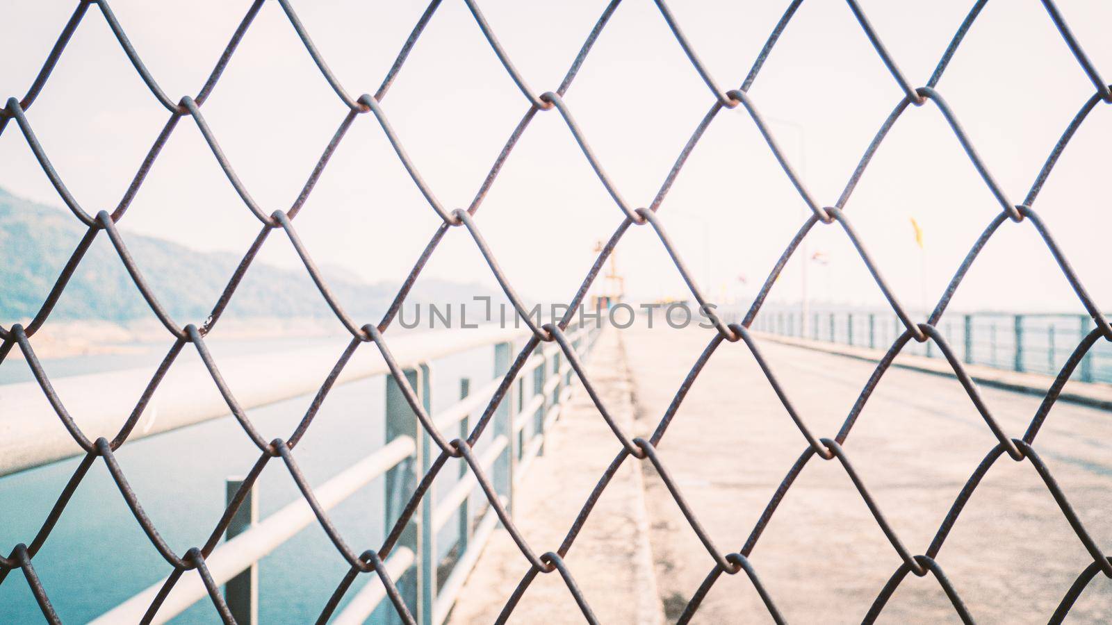 Chainlink fence. Wire fence. Metal net. Wire mesh. Metal grater grille background.