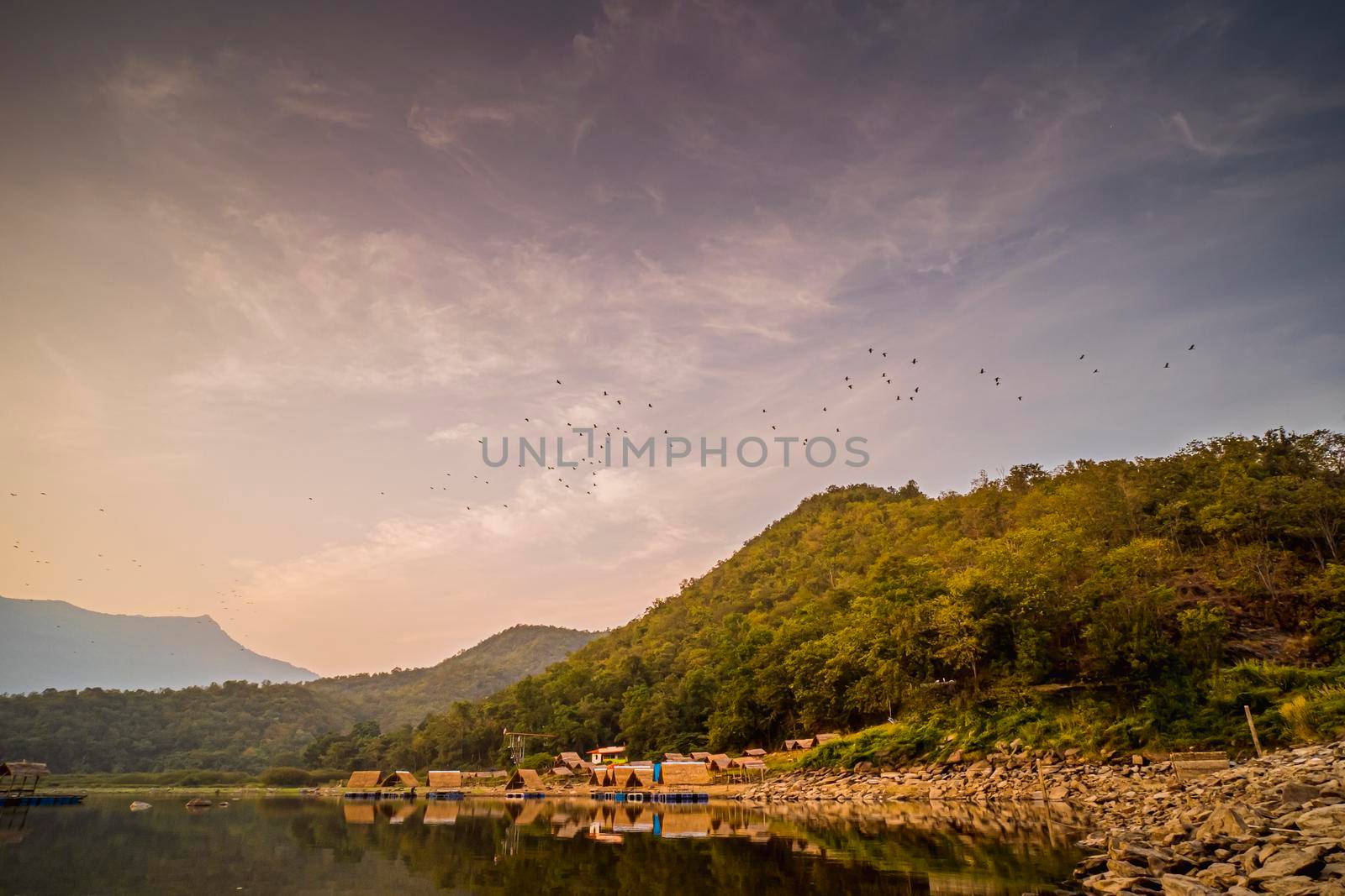 Panorama View of tropical lake and mountains. Small bamboo traditional cottage next the lake in Sukhothai Thailand