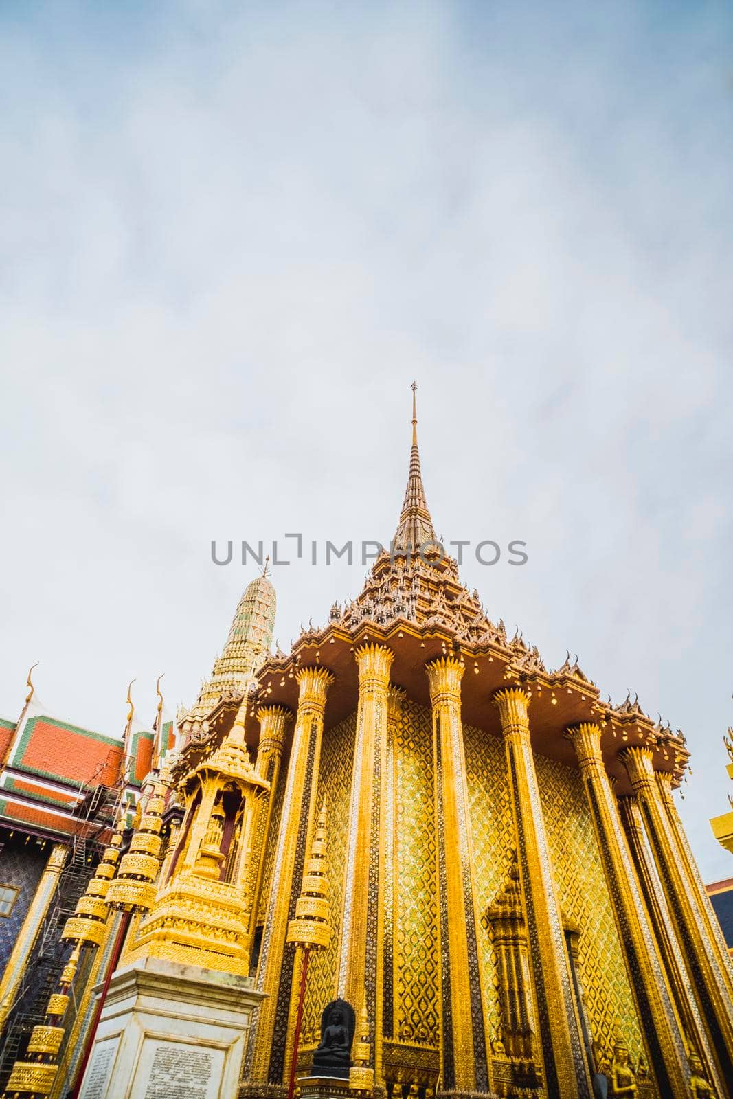 Golden Stupa of Temple of the Emerald Buddha.  Wat Phra Si Rattana Satsadaram.  Wat Phra Kaew. landmark of Bangkok Thailand with pink sky at dusk