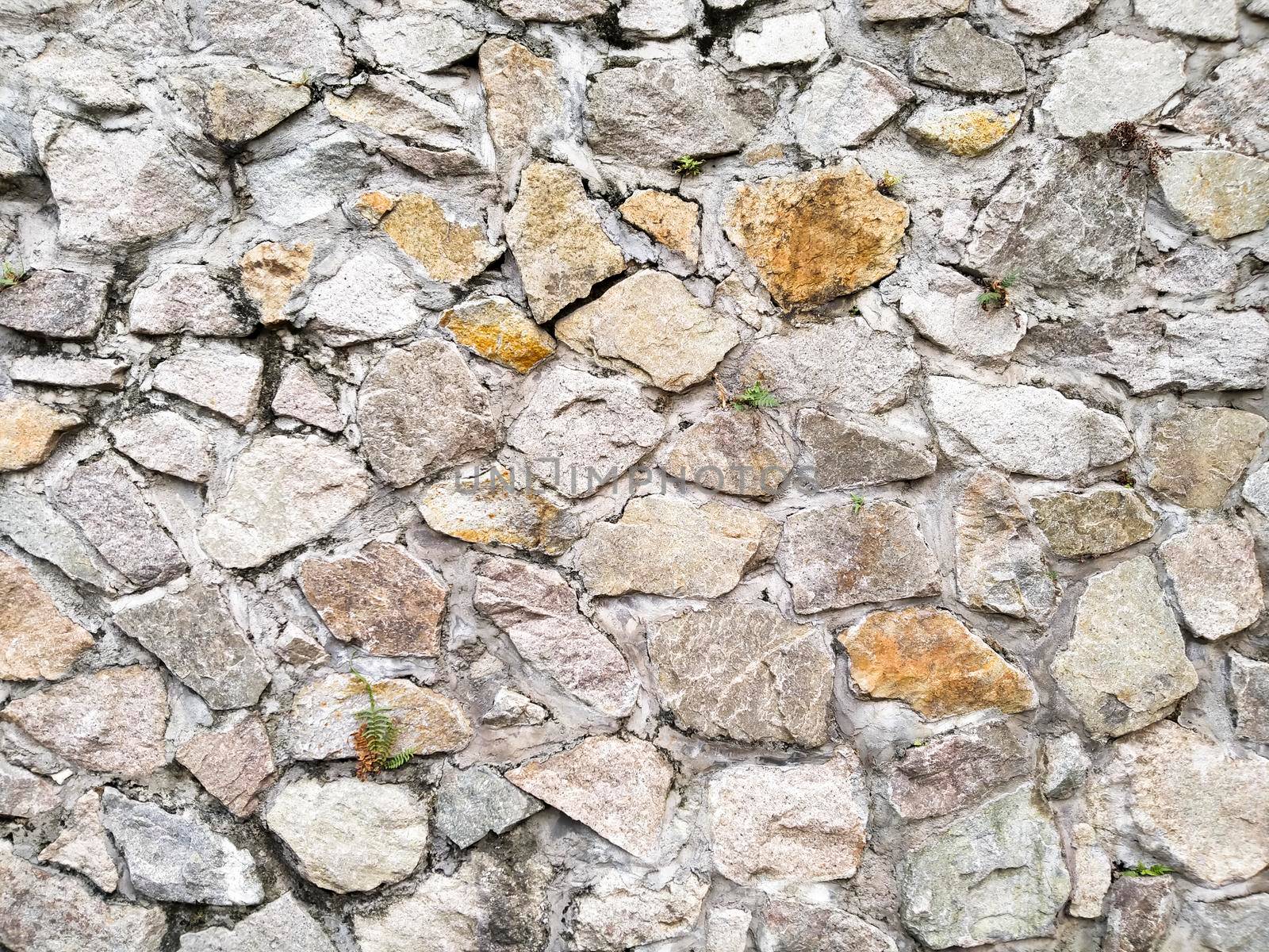 Natural stone wall texture  .  Old castle stone wall texture background . earth tone . rustic rough country decoration idea background for housing or fence design