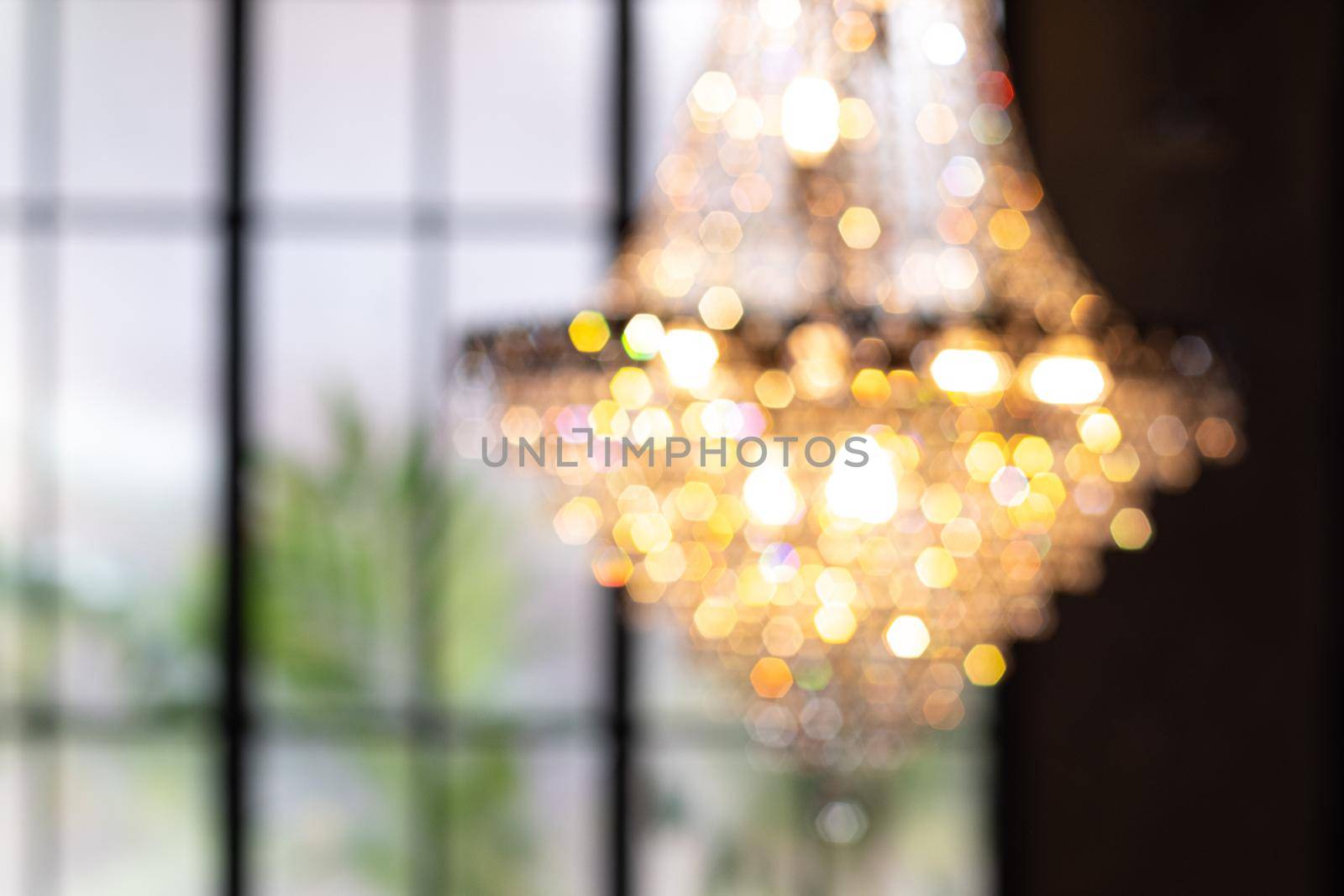 Abstract  blur chandelier with bokeh. Hanging Chandelier Lights Blurred Defocused Bokeh Background with blurred window on background by Petrichor