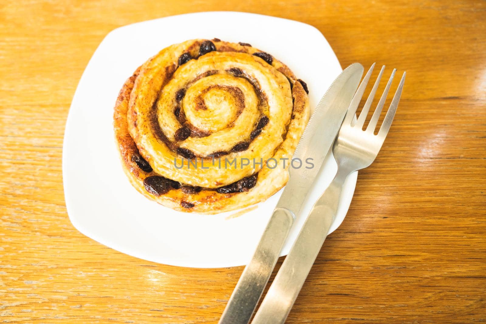 Cinnamon rolls buns baking on a white plate breakfast table Top view.