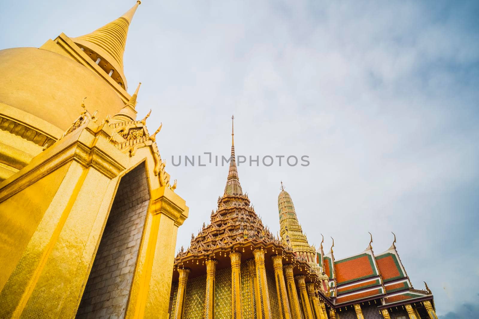 Golden Stupa of Temple of the Emerald Buddha.  Wat Phra Si Rattana Satsadaram.  Wat Phra Kaew. landmark of Bangkok Thailand with pink sky at dusk