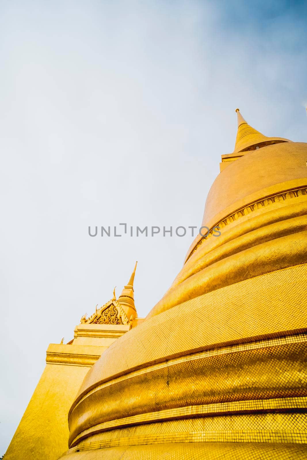 Golden Stupa of Temple of the Emerald Buddha.  Wat Phra Si Rattana Satsadaram.  Wat Phra Kaew. landmark of Bangkok Thailand with pink sky at dusk