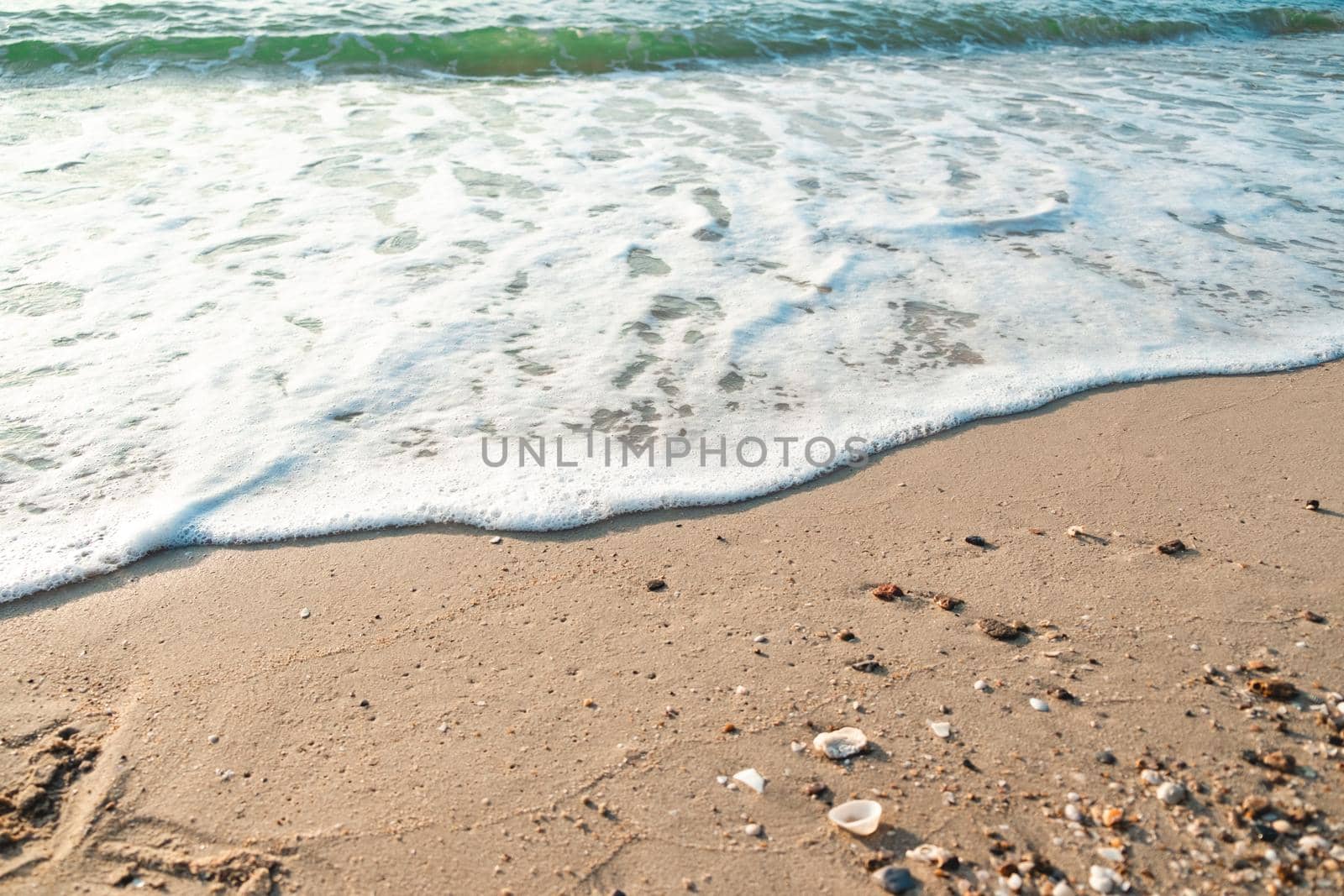 Close Up Wave Sand Beach Sea Foam.  Closeup of sea wave with foam on beach sand. Vacation Summer background