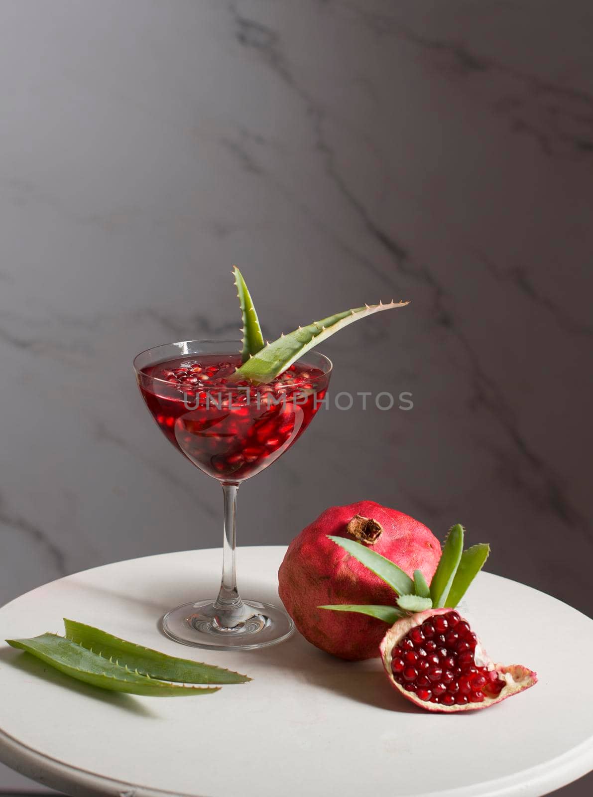 alternative medicine, pomegranate juice with aloe vera, still life, delicious medicine. High quality photo